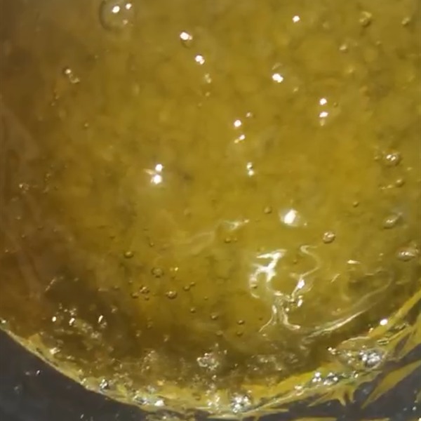 Amber live rosin in a glass jar, shot close