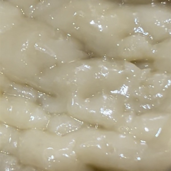 Whipped cream-coloured rosin badder in a jar