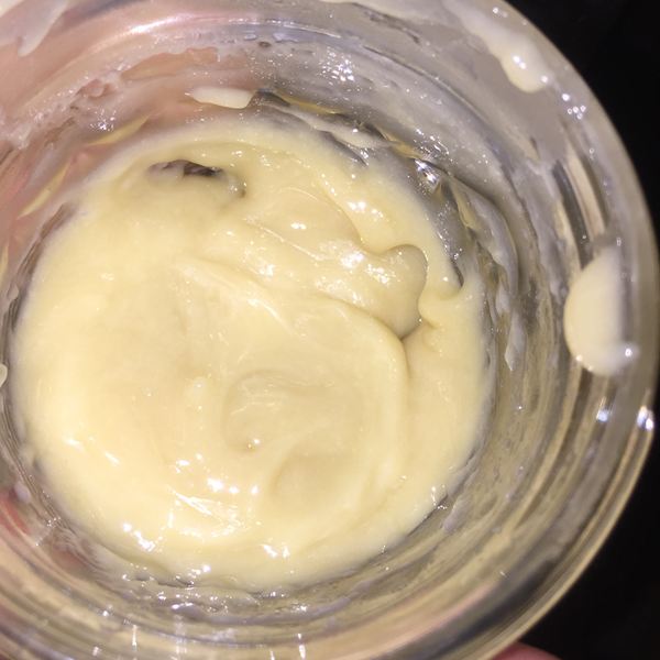 Macro into a jar of pale whipped rosin badder