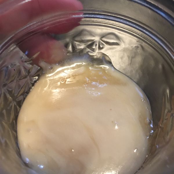 Glossy cream rosin patty in a glass jar